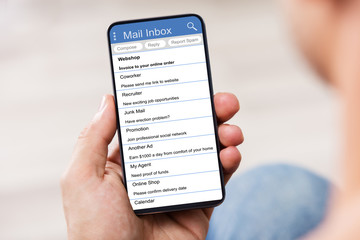 Man's Hand Holding Cell Phone With Blank Screen