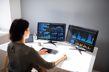 Stock market broker analyzing graph on computer