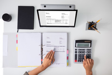 Accountant calculating tax at desk - obrazy, fototapety, plakaty