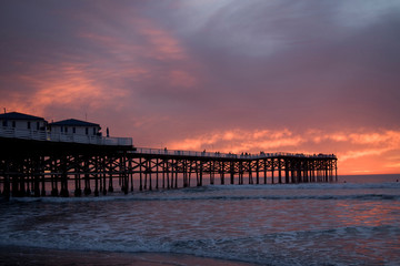 US, CA, San Diego. The sun sets over Crystal Pier in San Diego with brilliant clouds overhead.