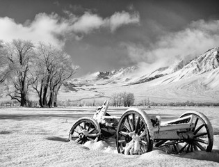 Fototapeta na wymiar USA, California, Bishop. Snow-covered vintage wagon in Owens Valley. 
