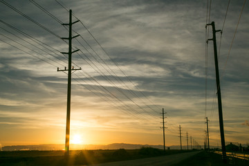 Fototapeta na wymiar Empty road and power lines at sunset, Salton Sea, California, USA.