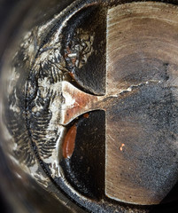 Disassembled engine piston system. Traces from the screw which got to the piston cylinder. Fingerprint bolt thread.