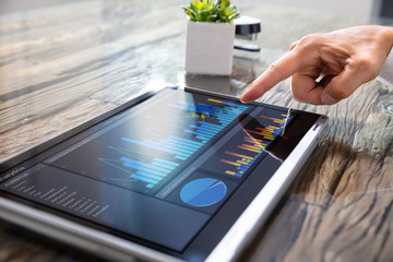 Businessman Analyzing Graph On Convertible Laptop