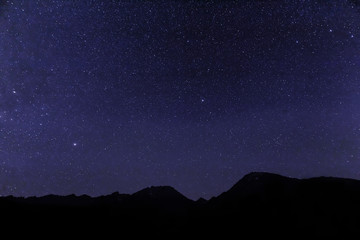 USA, California, Bishop. Star-filled night over mountains. 