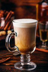 Coffee with Irish whiskey and whipped cream in glass