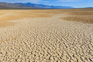 Textured sand stretches into the distance in Death Valley, California.