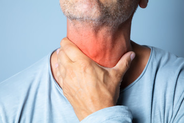 Close-up Of A Man Touching His Sore Throat