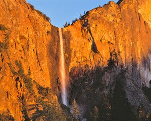 USA, California, Yosemite NP. Bridal Veil Falls seems to slip easily to the valley floor at...