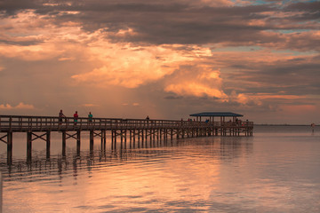 Fototapeta na wymiar Fishing pier off Safety Harbor, Florida. Sunset with people fishing
