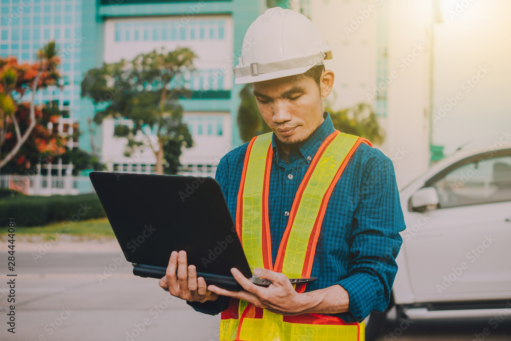Poster engineer holding computer working on side technology