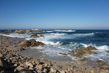 Waves, blue water and rocks along Monterey Peninsula, California coast