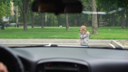 Attentive driver stopping car in front of little female child jumping on road