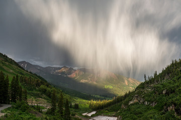 Virga and storm moving over mountains in Colorado