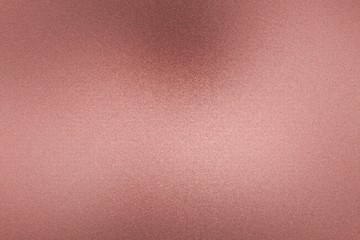 Brushed rose gold metallic wall with scratched surface, abstract texture background