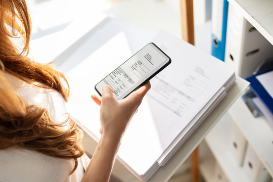 Businesswoman Taking Photograph In Office