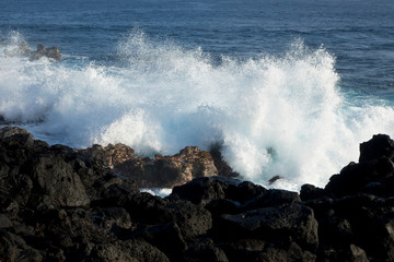 Huge waves crashing against lava rocks on coast of Big Island, Hawaii