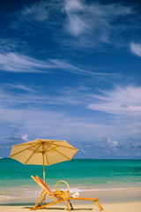 USA, Hawaii. Beach chair and umbrella