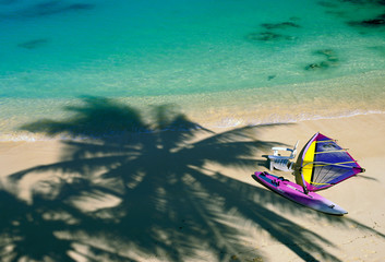 USA, Hawaii. Chair and windsurfer on beach