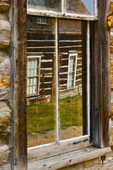 Reflection of old building in window glass, Virginia City, Montana.