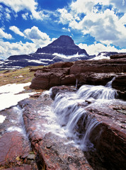 USA, Montana, Glacier NP. A small waterfall flows near the Logan Pass Visitors Center in Glacier National Park, Montana.