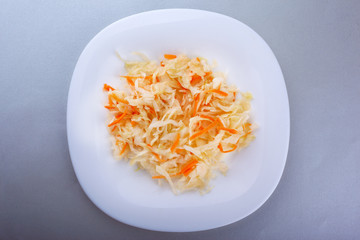 diet salad  flat lay,coleslaw and carrot salad, sauerkraut on a white plate on a gray background