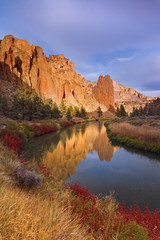 USA, Oregon, Smith Rock State Park. Rock cliffs reflect in Crooked River. 