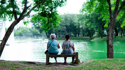 Two old women sitting in the park