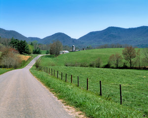 Fototapeta na wymiar USA, North Carolina, Asheville. A winding road leads to an isolated farm in the hills near Asheville, North Carolina.