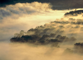 USA, North Dakota, Missouri River Valley. Morning fog glances off the silhouetted shapes of the Missouri River Valley, North Dakota, in this stunning aerial.