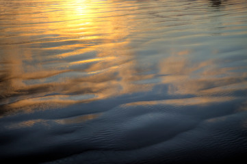 Sand reflecting sunset colors at low tide.