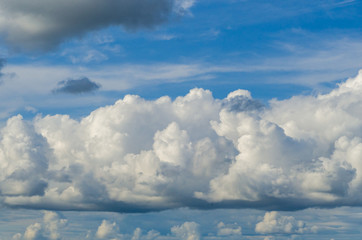 white fluffy and big cloud on a background of blue sky