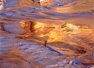 USA, Oregon, Face Rock Wayside. Sunset light reflects on the receding waves at Face Rock Wayside, Oregon.