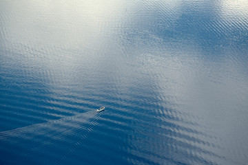 USA, Oregon, Crater Lake NP. A tour boat creates a wake at Crater Lake in Crater Lake National...