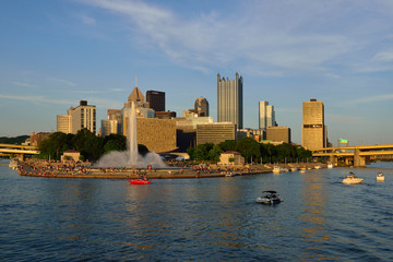 USA, Pennsylvania, Pittsburgh. Boats in front of Point State Park with downtown Pittsburgh in the...