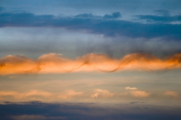 USA, Utah, Arches National Park. Sunset sky illumines spiral cloud. 
