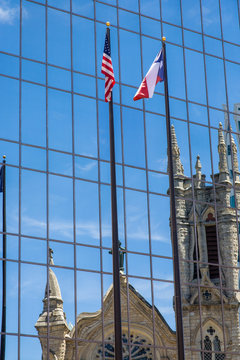 USA, Austin, Texas, Reflection of St. Mary Cathedral and its Gothic Spires, in a newer glass building. Designed by Texas architect Nicholas Clayton (1884) oldest Catholic church in Austin.