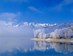 Mt. Timpanogas, low clouds, Deer Creek Reservoir and rimmed trees, Wasatch Mountains, Utah.