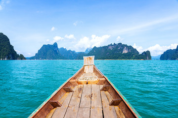 Wooden boat in lake with limestone mountain range background