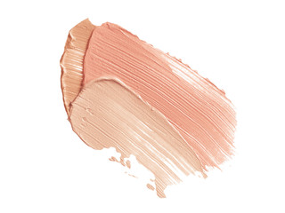Color corrector strokes isolated on white background. Beige and pink color correcting cream concealer smudge smear swatch sample. Makeup foundation creamy texture