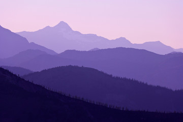 USA, Washington, Pasayten Wilderness. Sunset on layers of mountains in purple haze. 