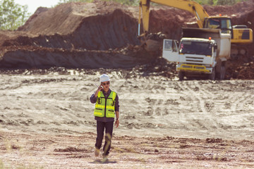 Portrait of asian male supervisor walking in mine soil field location