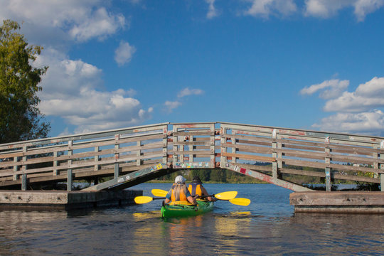 USA, Washington State, Seattle. Two Women Paddle A Two-person Sea Kayak On Lake Washington, Near The Arboretum.