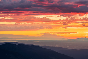USA. Washington State. Layers of sunset clouds above north Puget Sound, a look at Bellingham to...