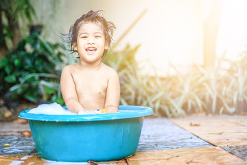 The little girl was bathed in a bathtub and Happily with happy smile cute and beautiful on holiday