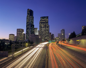 Fototapeta na wymiar WA, Seattle, Seattle skyline with traffic on I-5 at night