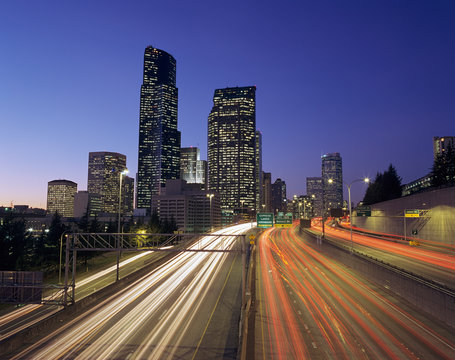 WA, Seattle, Seattle skyline with traffic on I-5 at night