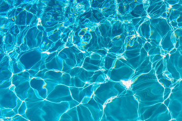 Reflections and patterns of light in a swimming pool.