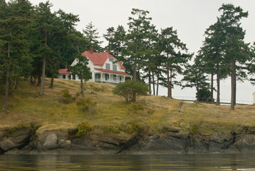 Fototapeta na wymiar USA, WA, San Juan Islands. Turn Point Lighthouse on Stuart Island was built in 1893. This duplex home housed the keeper and his family on one side, assistant keeper and his family on the other.