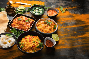 Assorted indian food on black background..